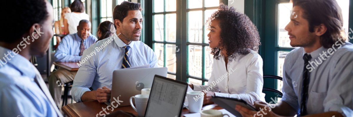 stock-photo-business-team-having-informal-meeting-around-table-in-coffee-shop-1320223934