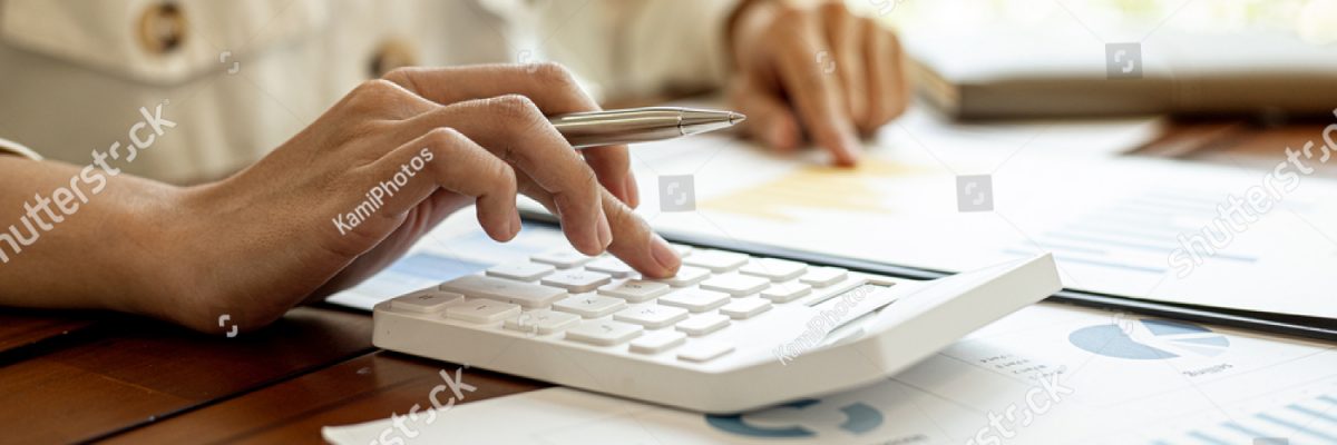 stock-photo-close-up-of-a-businesswoman-using-a-white-calculator-a-financial-businessman-examining-the-1921527362