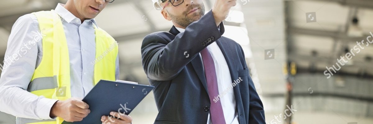 stock-photo-mid-adult-businessman-with-supervisor-having-discussion-in-metal-industry-531845947